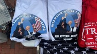 On the sidelines of the Republican nominating convention, a street vendor sells T-shirts with the portrait of former US President and candidate Donald Trump.