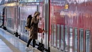 Taking the board on the train: A young woman boards a train at Frankfurt Central Station.