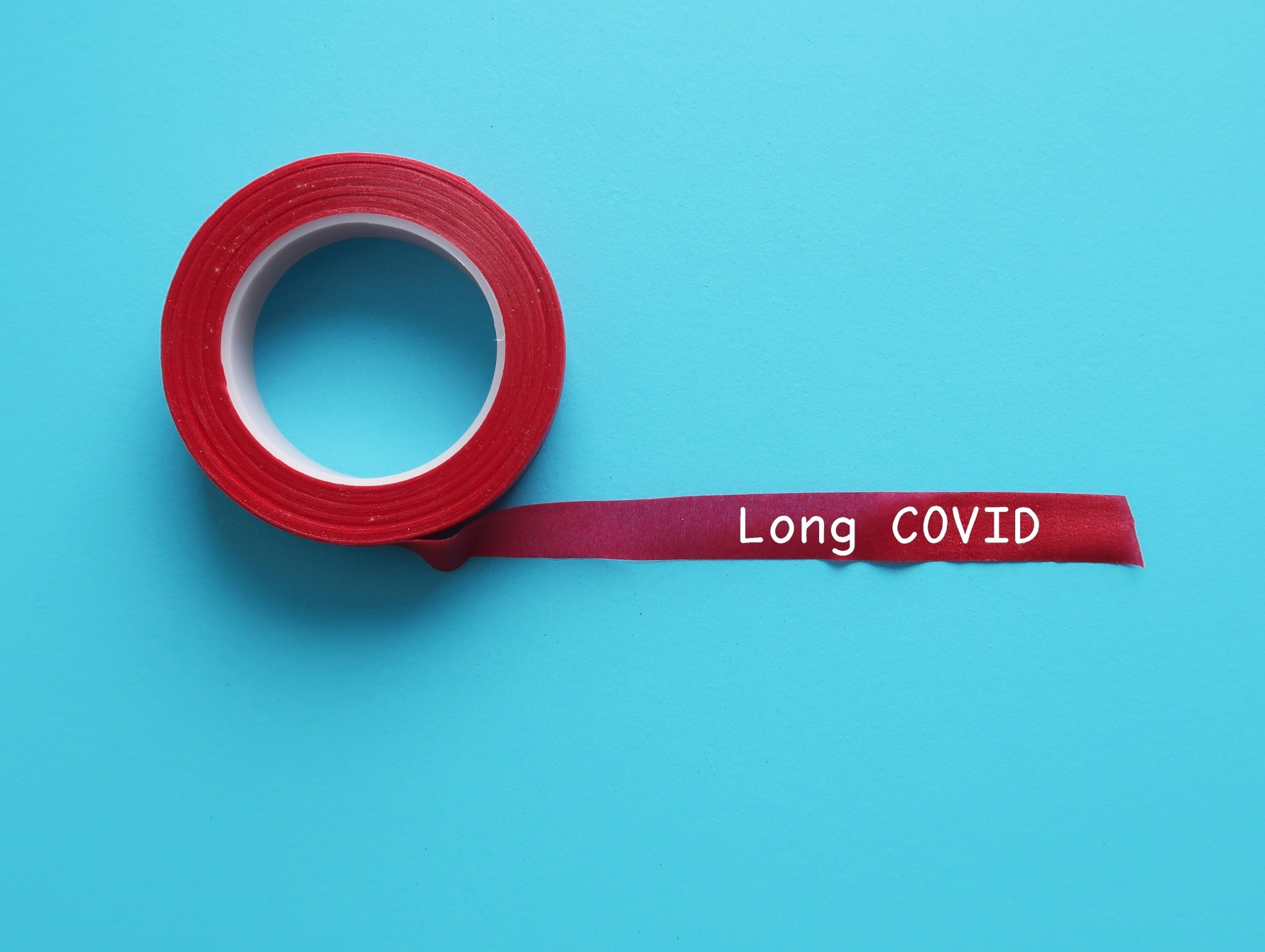 Red long ribbon on blue background with handwritten word LONG COVID.