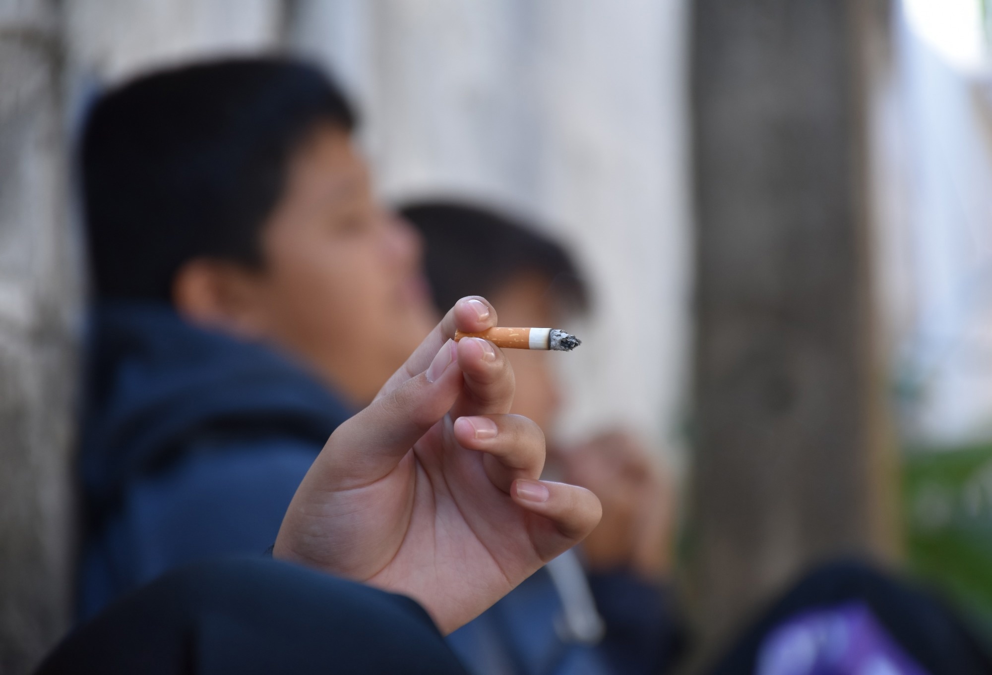 boys sitting and smoking together.