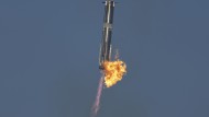 The booster of SpaceX's Starship rocket returns to the launch pad during a test flight from the Starbase in Boca Chica.