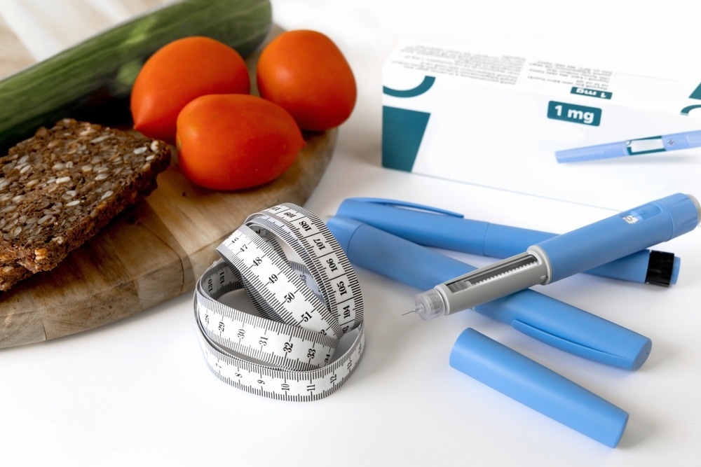 A composition featuring healthy foods, including a cucumber, tomatoes, and whole-grain bread, alongside a measuring tape and a semaglutide injection pen. The semaglutide medication box is visible in the background, highlighting its use in weight management and health.