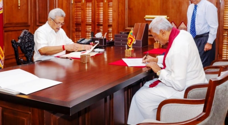 Chamal Rajapaksa signing a document after swearing in as the State Minister of National Security, Home Affairs, and Disaster Management