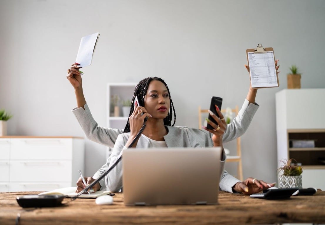 Woman at desk multitasking