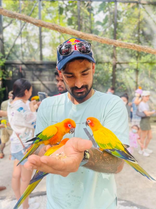 Litton Das feeding parrots