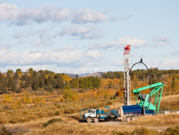 Oil drilling rig in a field in Alberta