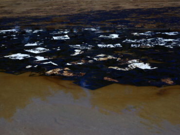 Oil spill on the sand of a beach