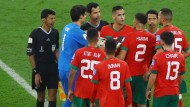 Moroccan players harass the referee after the game.