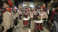 Christmas parade: Palestinian scouts pave the way for the patriarch through Jerusalem.
