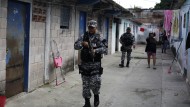 A police officer patrols in the fight against gang crime December 3, 2022 in Soyapango, El Salavador.