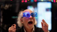 A trader on New York's Wall Street celebrates the new stock market year.
