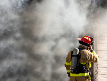 Firefighter responding to a building fire.