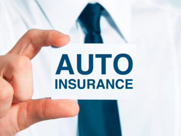 Man holding card saying 'auto insurance'