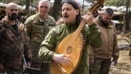 Taras Kompanichenko, a well-known Ukrainian artist and Territorial Defense Forces volunteer, plays the kobza, a folk stringed instrument, on Easter Eve 2022 at a military position outside Kiev.