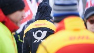 Post and DHL logos are on the jackets of Deutsche Post demonstrators.