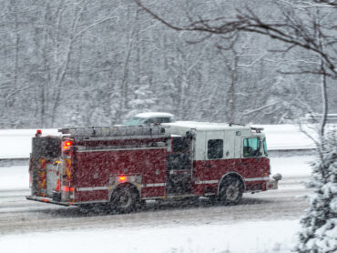 Firefighters responding to an incident in snowy weather