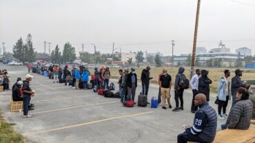 Residents of Yellowknife lining up to register for a flight to Calgary.