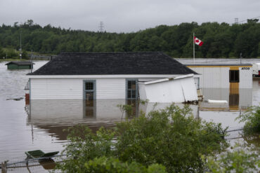 Buildings are seen in floodwater following a major rain event in Halifax on Saturday, July 22, 2023. A long procession of intense thunderstorms have dumped record amounts of rain across a wide swath of Nova Scotia, causing flash flooding, road washouts and power outages