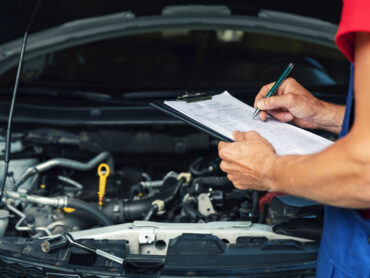 Car maintenance and repair mechanic writing checklist